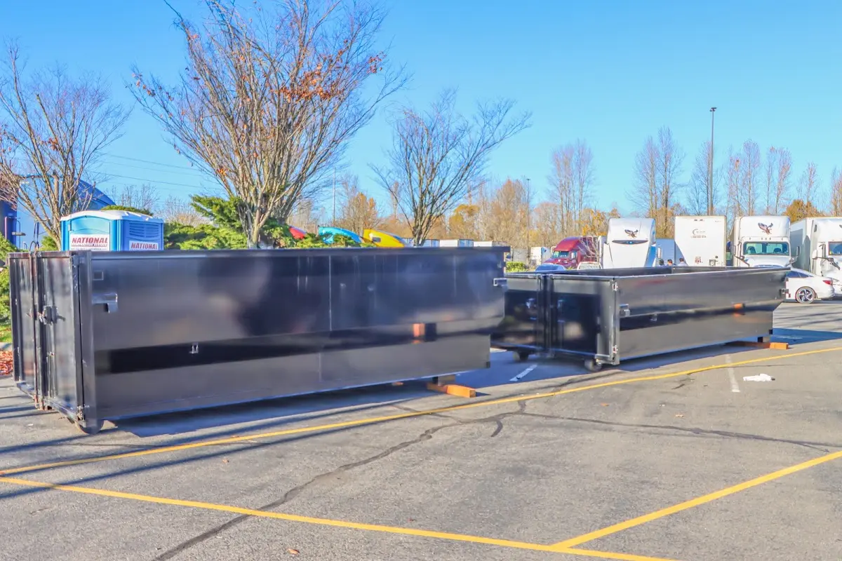 Professional dumpster rental service with roll-off container on residential driveway in Thibodaux